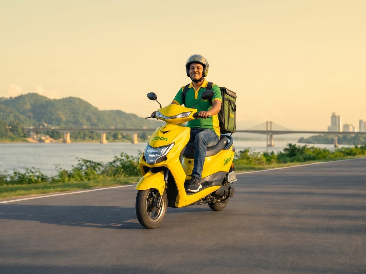 Jibon Electric delivery rider on a yellow electric scooter